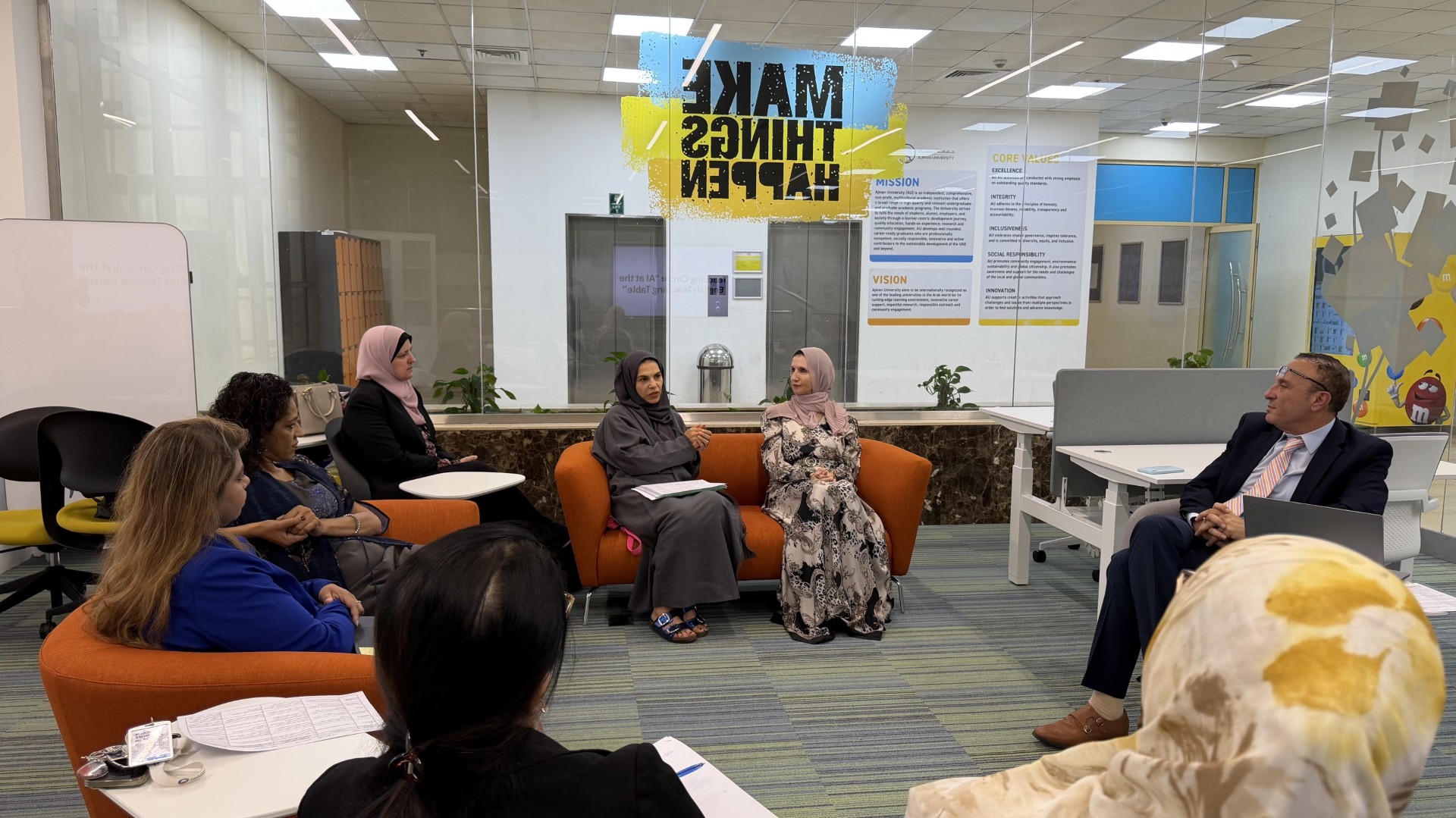 People in a meeting room discussing ideas.