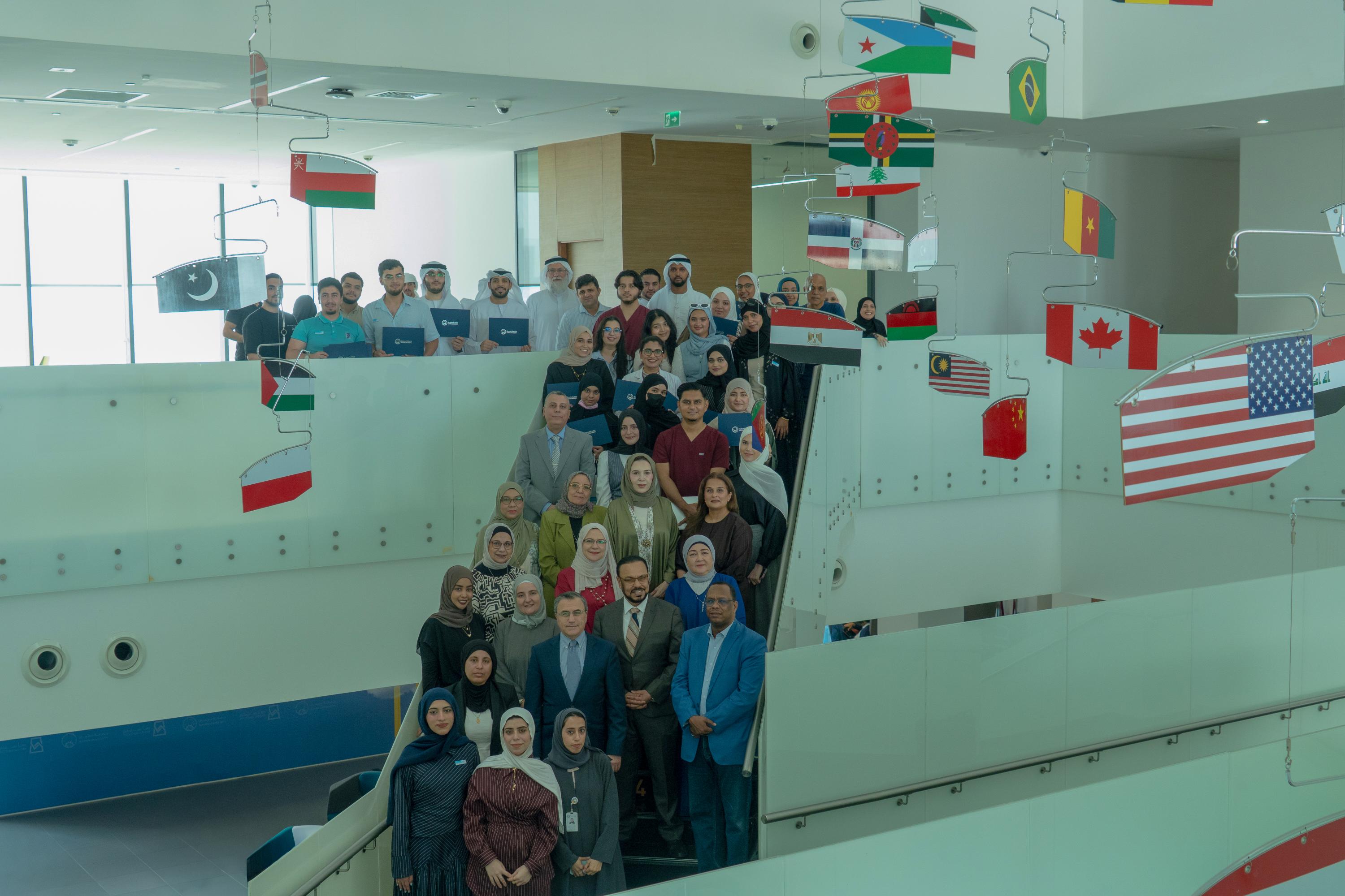 Group of people on stairs with international flags.